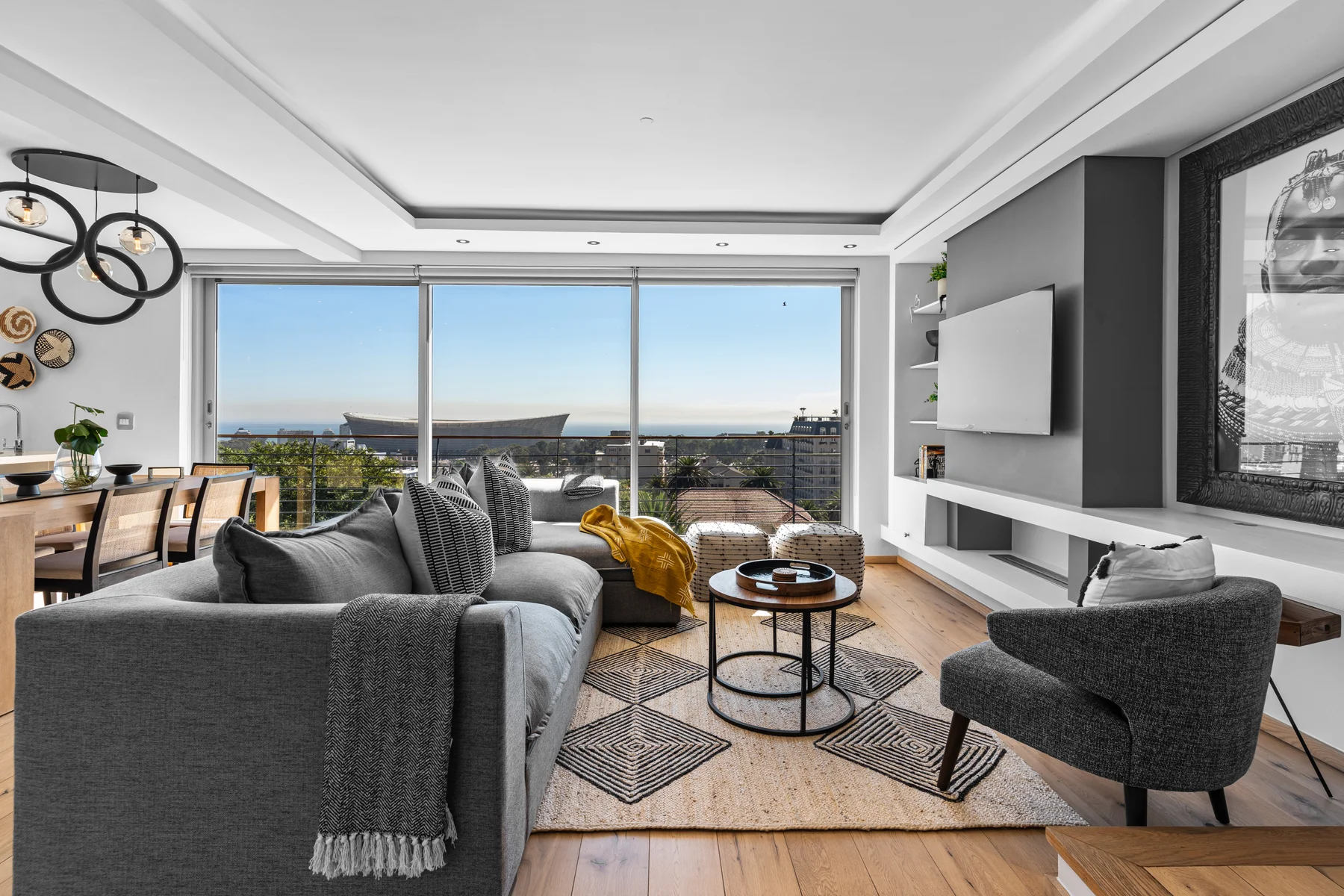 Seven on T living room opening toward the balcony and Cape Town skyline